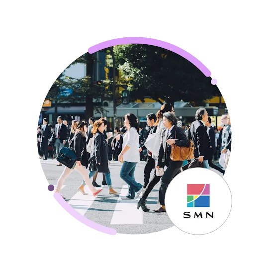 People crossing a bustling city street, with an SMN logo.