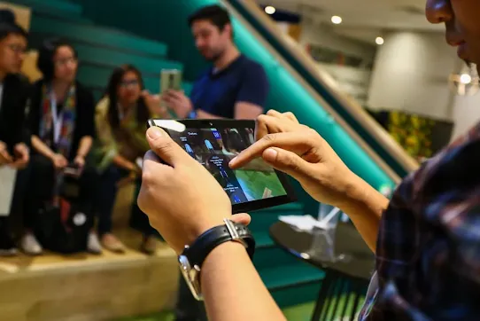 A person with tablet phone in hand